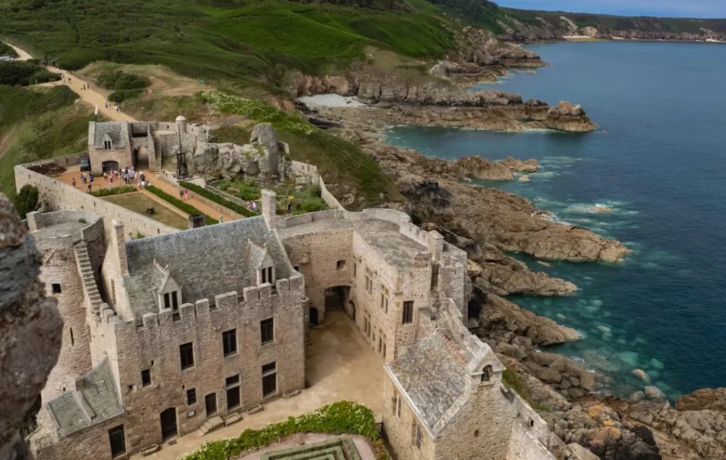 A castle sits on a rocky coastline.