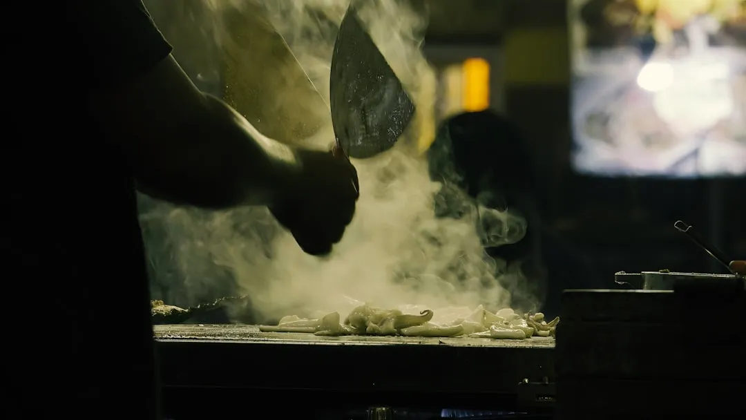 Chef cooking food with steam rising