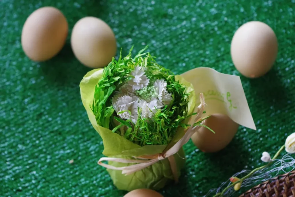 A dish is surrounded by eggs and greenery.