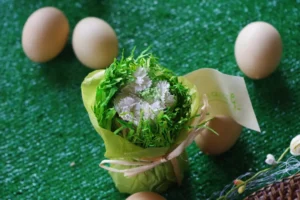 A dish is surrounded by eggs and greenery.