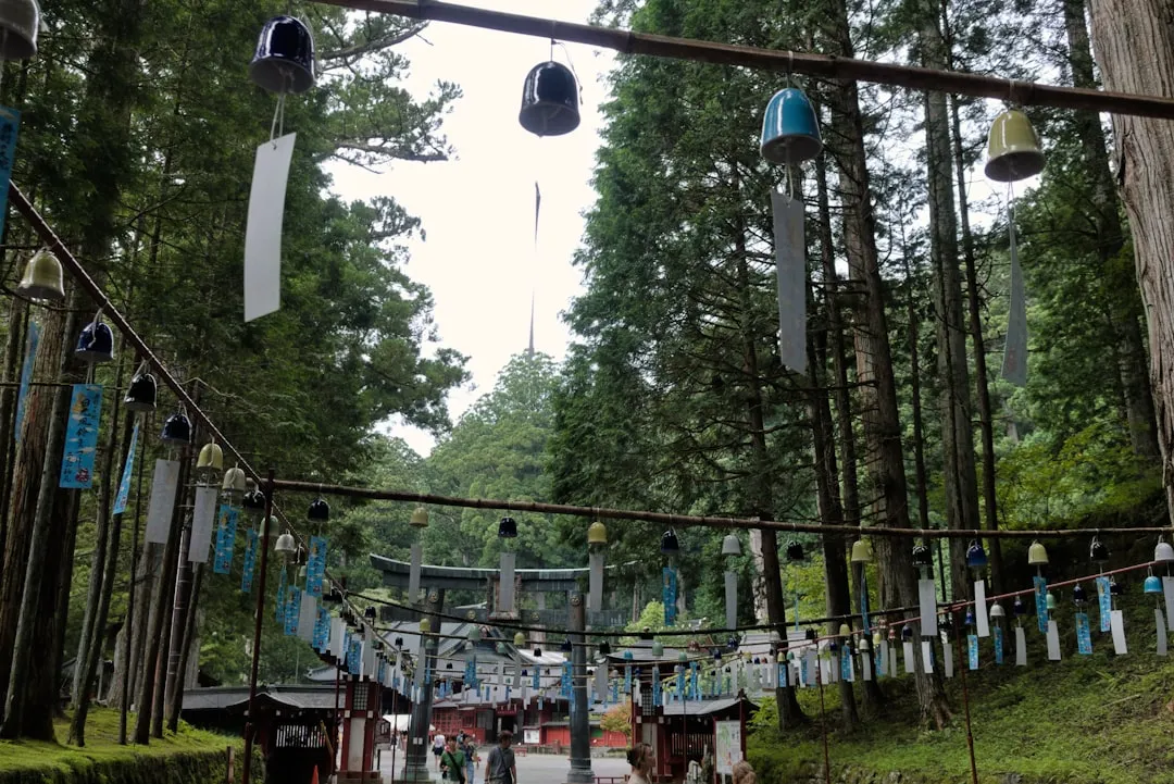 Wind chimes hanging along a path to a shrine