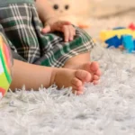 a baby is playing with toys on the floor