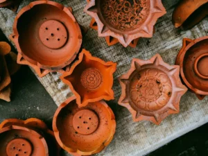 Several clay diyas arranged on a textured surface