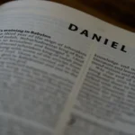 a close up of an open book with the word daniel on it
