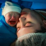 Mother and newborn share an intimate moment.