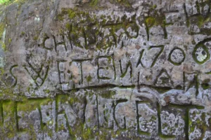a stone wall with writing on it