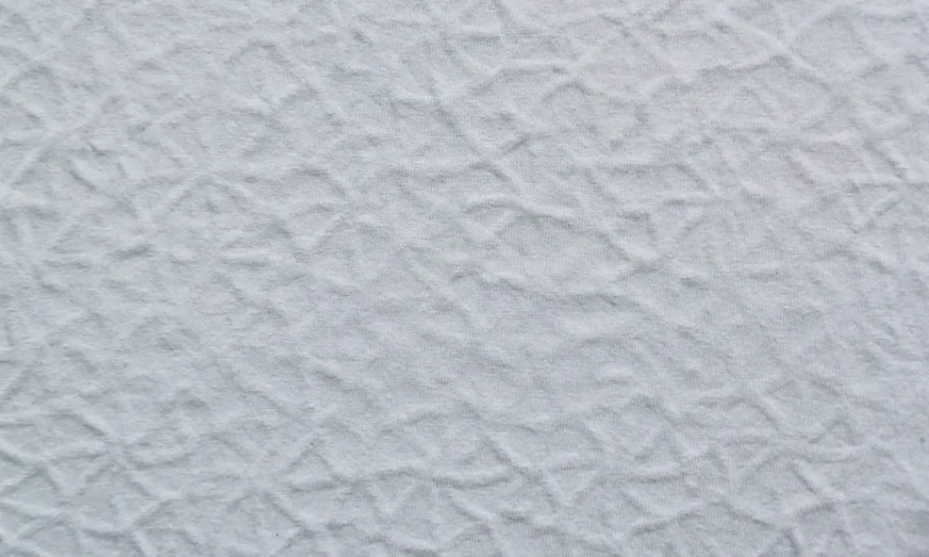 a close up of a white textured wall