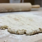 white dough on brown wooden table