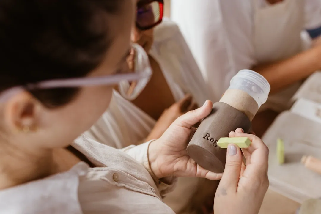 A woman is holding a bottle and looking at it