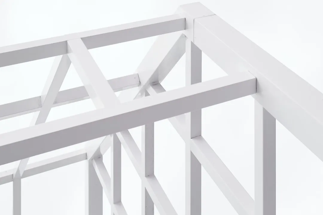 White geometric wooden structure against a white background