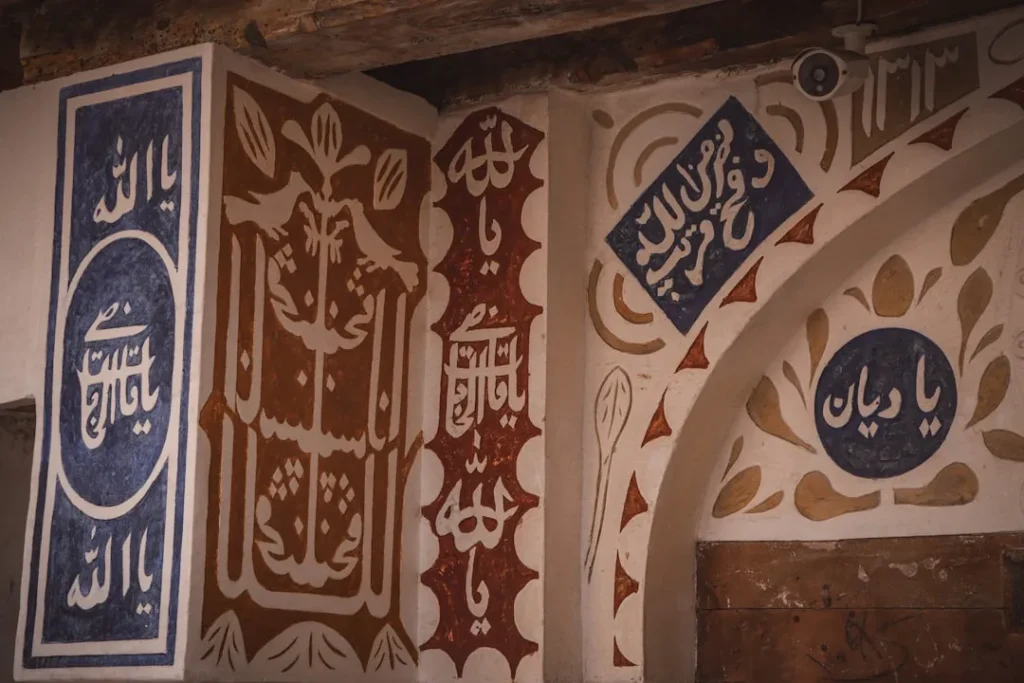 a close up of a wall with arabic writing on it