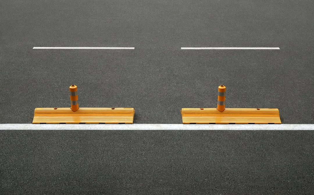 a couple of wooden posts sitting on the side of a road