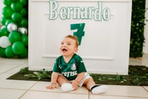 boy in green polo shirt sitting on white ceramic floor tiles