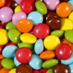assorted color candies on brown wooden table