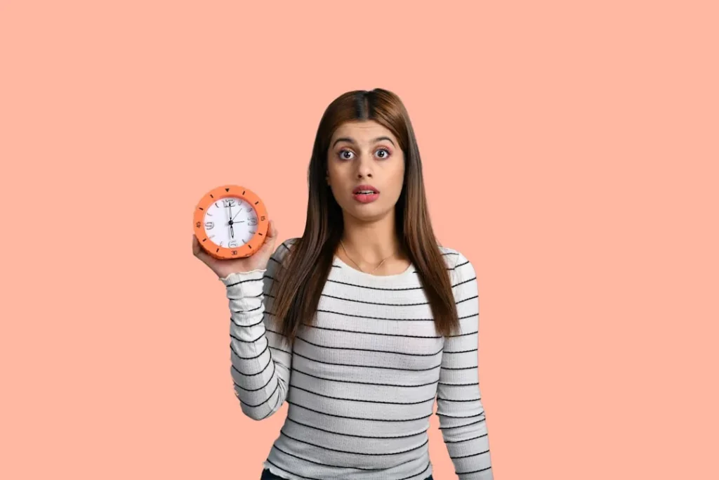 a woman holding a clock