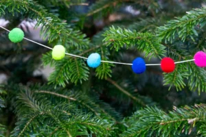 Colorful pom-pom garland on a christmas tree