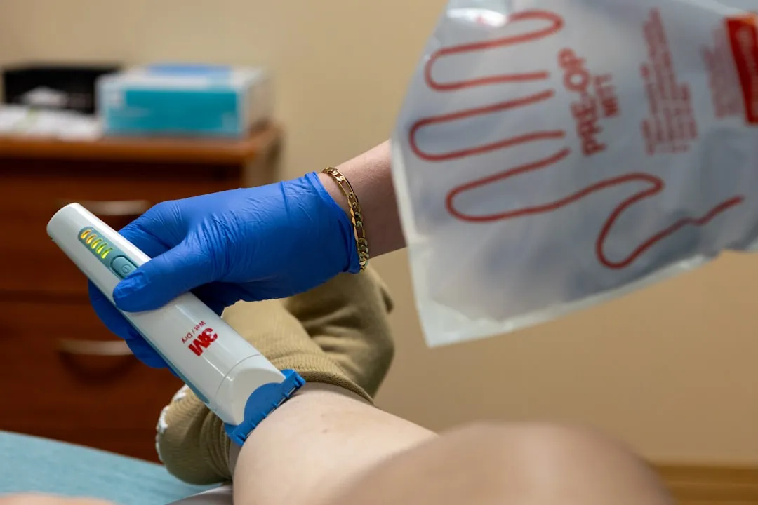 A medical worker is operating a device.
