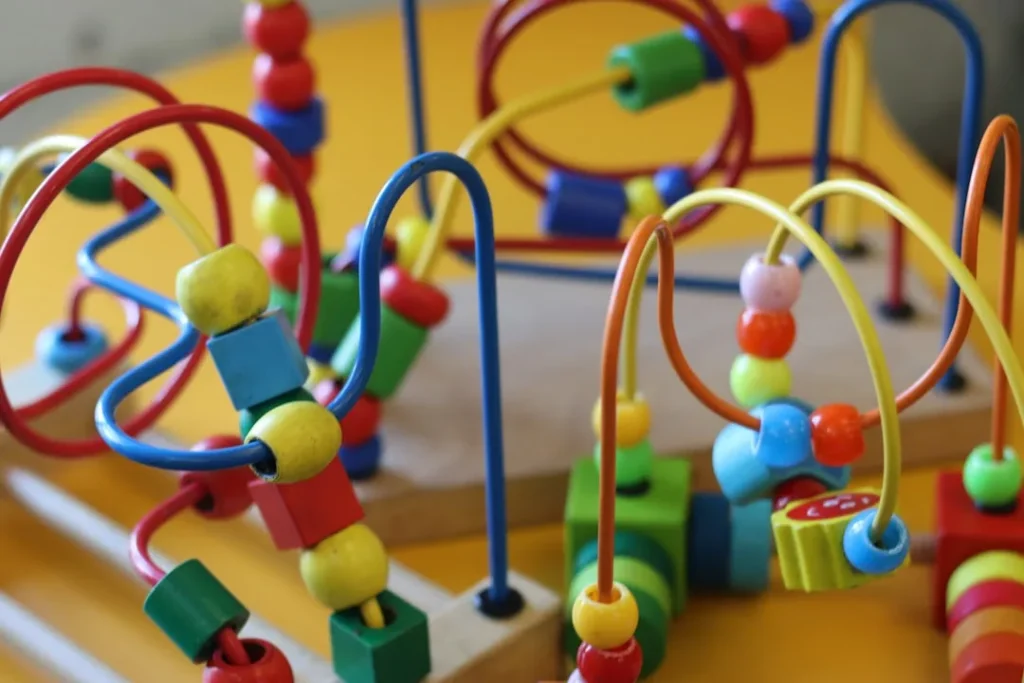 Colorful wooden beads on a wire bead maze.