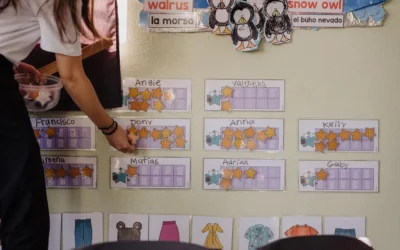 A woman standing in front of a bulletin board