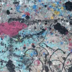 a close up of a wall with paint splattered on it