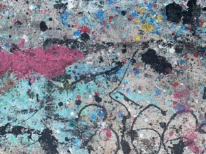 a close up of a wall with paint splattered on it
