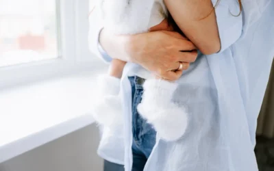 A mother holds a baby with soft socks.