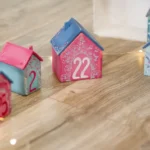 red and white ceramic house on brown wooden table