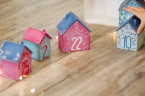 red and white ceramic house on brown wooden table