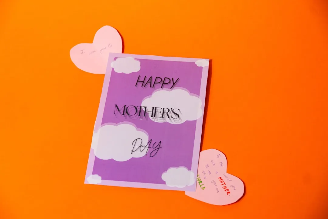 Happy mother's day card with hearts on orange background