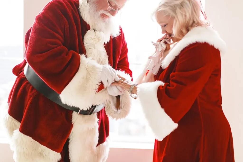 a man and a woman dressed as santa claus