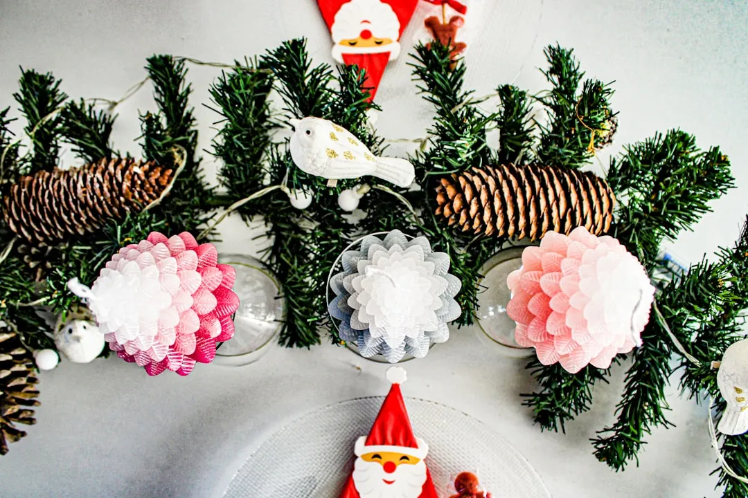 a table topped with christmas decorations and pine cones