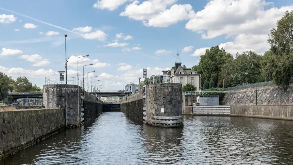 Canal lock with historic building in the background