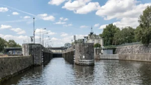 Canal lock with historic building in the background