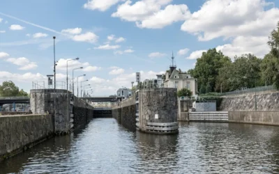 Canal lock with historic building in the background