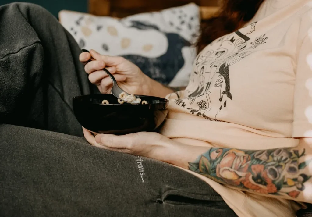 person holding black ceramic bowl