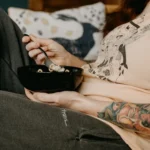 person holding black ceramic bowl