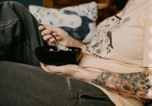 person holding black ceramic bowl
