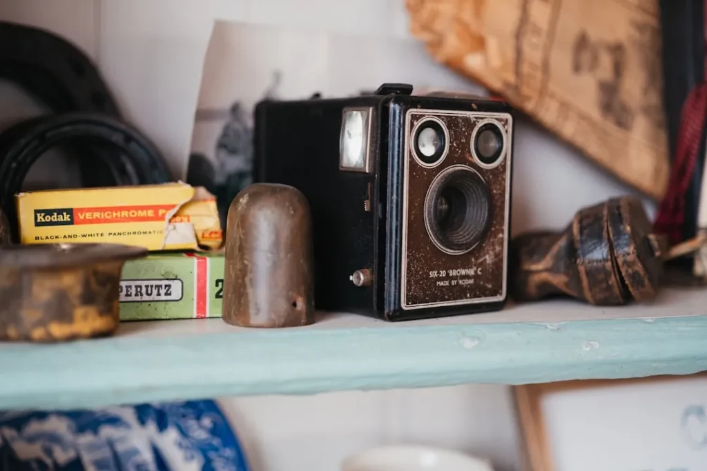 Vintage box camera with kodak film box on shelf