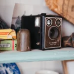 Vintage box camera with kodak film box on shelf