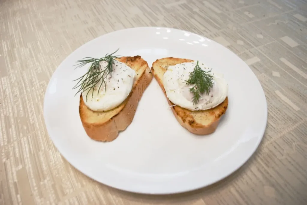 bread with green leaf on white ceramic plate