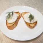 bread with green leaf on white ceramic plate
