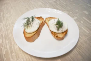bread with green leaf on white ceramic plate