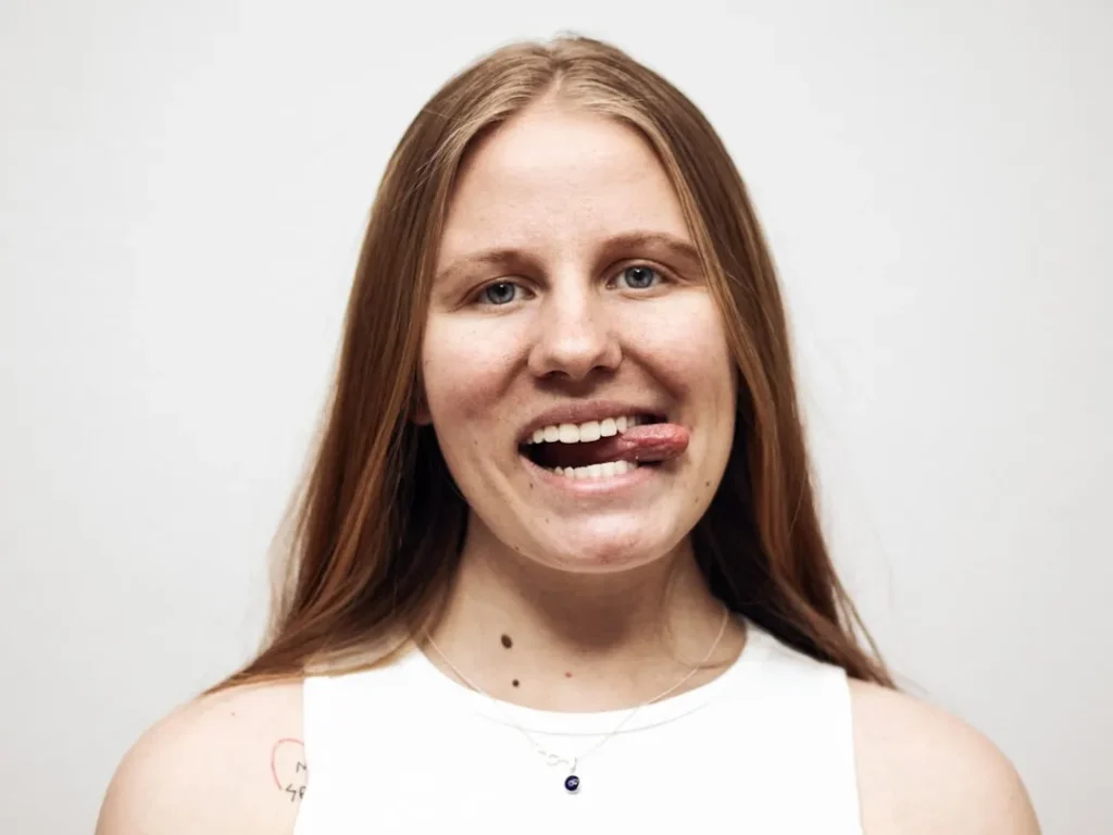 a woman with a toothbrush in her mouth