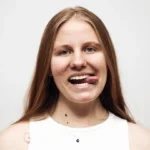 a woman with a toothbrush in her mouth