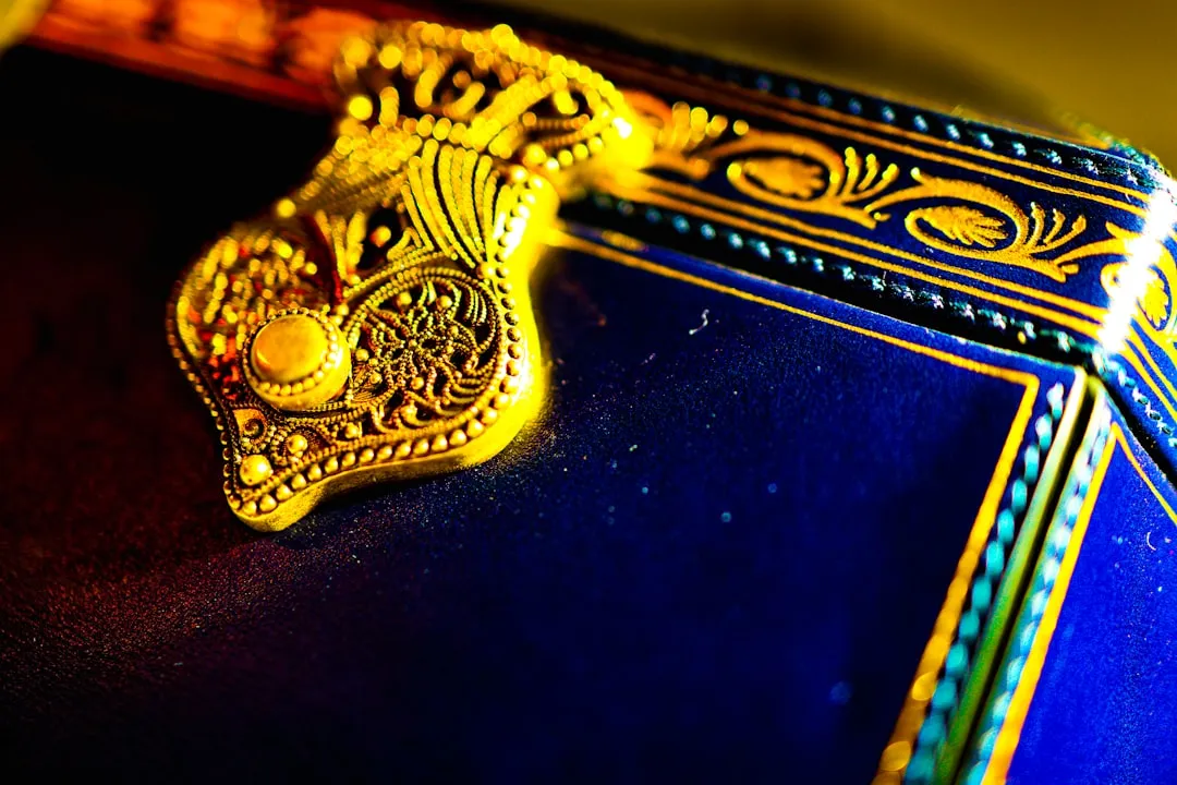 Ornate gold clasp on a dark blue decorative box.