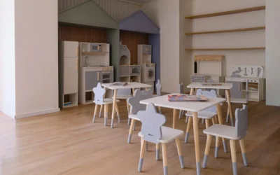 Children's playroom with small tables and chairs.
